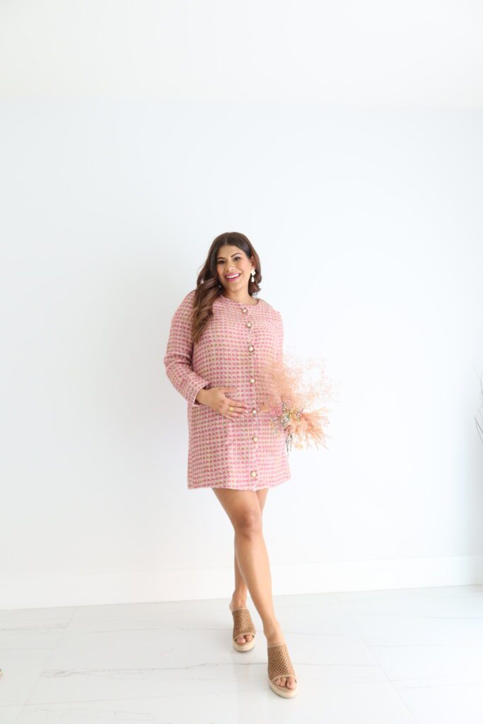 this polished pink tweed mini dress. This girl boss vibe is working for you, no doubt! This dress features a scoop neckline, scallop detailing, non-functional costume pearl buttons down the front and a back zipper closure. Model is wearing an x-small. 